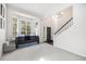 Inviting living room with a bay window, neutral decor, and an adjacent staircase at 5265 S Cathay Way, Centennial, CO 80015