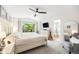 Bright main bedroom boasts natural light, a ceiling fan, and an ensuite bathroom with a tub at 5265 S Cathay Way, Centennial, CO 80015