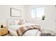 Cozy bedroom features a large window, soft carpet, and neutral tones at 2105 S Galapago St # 4, Denver, CO 80223