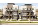 Contemporary townhomes featuring private balconies, well-maintained lawns, and modern architectural details at 2105 S Galapago St # 4, Denver, CO 80223