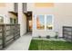 Inviting entrance to a modern home with a well-manicured lawn and contemporary wooden fence at 2105 S Galapago St # 4, Denver, CO 80223