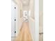 Bright hallway leads to bedroom, featuring light wood floors and minimalist decor at 2105 S Galapago St # 4, Denver, CO 80223