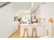 Contemporary kitchen with barstool seating flows into the adjacent dining area at 2105 S Galapago St # 4, Denver, CO 80223