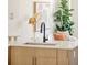 A well-lit kitchen with a modern sink and faucet complements elegant decor at 2105 S Galapago St # 4, Denver, CO 80223
