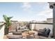 Relaxing rooftop deck features stylish outdoor furniture and expansive views at 2105 S Galapago St # 4, Denver, CO 80223