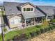 Aerial view of home with covered porch, manicured lawn, and black fence at 3214 Heron Lakes Pkwy, Berthoud, CO 80513