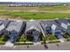 Stunning aerial view of a modern home nestled on a golf course with picturesque community landscape at 3214 Heron Lakes Pkwy, Berthoud, CO 80513