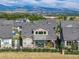 Aerial view showcases the home's exterior, backyard, and mountain views at 3214 Heron Lakes Pkwy, Berthoud, CO 80513