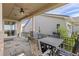 Back porch with a ceiling fan, stone pillars, and a view of the backyard at 3214 Heron Lakes Pkwy, Berthoud, CO 80513