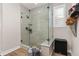 Modern bathroom featuring a glass enclosed shower with neutral tile and pebble floor at 3214 Heron Lakes Pkwy, Berthoud, CO 80513