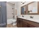 Bathroom with double sink vanity, tile shower, and modern fixtures at 3214 Heron Lakes Pkwy, Berthoud, CO 80513