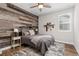 Cozy bedroom with wood-paneled accent wall and a rustic feel at 3214 Heron Lakes Pkwy, Berthoud, CO 80513