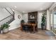 Bright dining room features a fireplace, wood floors, and access to the patio at 3214 Heron Lakes Pkwy, Berthoud, CO 80513