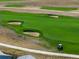 Aerial shot of golf course with sand traps, green fairways, and a golf cart at 3214 Heron Lakes Pkwy, Berthoud, CO 80513