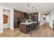 Modern kitchen with dark wood cabinets, island, and stainless steel appliances at 3214 Heron Lakes Pkwy, Berthoud, CO 80513