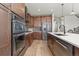 Modern kitchen with stainless steel appliances and island at 3214 Heron Lakes Pkwy, Berthoud, CO 80513