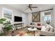 Cozy living room with a modern sectional sofa, stylish rug, and a sliding barn door at 3214 Heron Lakes Pkwy, Berthoud, CO 80513