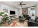 Modern living room featuring hardwood floors, a ceiling fan, and a stylish barn door at 3214 Heron Lakes Pkwy, Berthoud, CO 80513