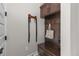 Mudroom with built in bench seating, coat hooks, and cabinets above at 3214 Heron Lakes Pkwy, Berthoud, CO 80513