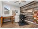 Cozy office space with rustic wood accent wall, natural light, and a ceiling fan at 3214 Heron Lakes Pkwy, Berthoud, CO 80513