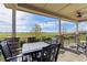 Outdoor patio with picturesque view and black chairs and table set at 3214 Heron Lakes Pkwy, Berthoud, CO 80513