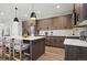 Modern kitchen with stainless appliances, quartz countertops, island with bar seating, and pendant lighting at 4127 Tejon St, Denver, CO 80211