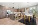 Open kitchen and dining area with stainless appliances, island seating, and modern light fixtures at 4127 Tejon St, Denver, CO 80211