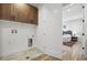 Laundry room with cabinets, tile flooring and a glimpse into the bright main bedroom at 4127 Tejon St, Denver, CO 80211