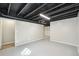 Spacious unfinished basement with exposed ceiling, painted floors, and ample storage space at 9455 W 81St Ave # A, Arvada, CO 80005
