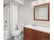 Clean bathroom featuring a classic vanity, toilet, framed mirror, and bathtub with shower at 9455 W 81St Ave # A, Arvada, CO 80005