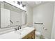 Modern bathroom featuring a vanity with drawers, decorative mirror and accessible features at 9455 W 81St Ave # A, Arvada, CO 80005