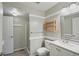 Well-lit bathroom with a shower, vanity with sink, and decorative shelving at 9455 W 81St Ave # A, Arvada, CO 80005