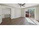 Bright bedroom featuring modern wood flooring, ceiling fan, and access to a deck through sliding glass doors at 9455 W 81St Ave # A, Arvada, CO 80005