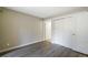 Neutral bedroom featuring modern wood flooring, closet doors, and an ensuite bathroom at 9455 W 81St Ave # A, Arvada, CO 80005