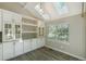 Bright dining area featuring modern cabinets, skylights, and a view of the outdoors at 9455 W 81St Ave # A, Arvada, CO 80005