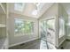 Sun-filled dining area with built-in cabinetry, skylights, and sliding glass doors at 9455 W 81St Ave # A, Arvada, CO 80005