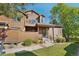 Attractive townhouse with wood facade, small porch and landscaped front yard and walkway at 9455 W 81St Ave # A, Arvada, CO 80005