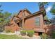 Charming townhouse featuring a wood exterior, landscaped yard, and inviting entryway on a sunny day at 9455 W 81St Ave # A, Arvada, CO 80005