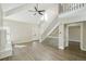 Bright living area with high ceilings, a modern staircase, wood flooring, and a painted brick fireplace at 9455 W 81St Ave # A, Arvada, CO 80005