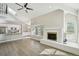 Spacious living area featuring fireplace, modern wood floors, with an adjacent kitchen at 9455 W 81St Ave # A, Arvada, CO 80005
