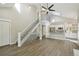 Open-concept living space with white staircase, sleek flooring, and kitchen bar, creating a seamless flow at 9455 W 81St Ave # A, Arvada, CO 80005