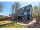 A home with a deck and backyard, with a set of stairs leading down to a stone paved area at 10486 Cheetah Winds, Lone Tree, CO 80124