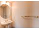 Bathroom showcasing a pedestal sink, round mirror, and towel rack against neutral walls at 10486 Cheetah Winds, Lone Tree, CO 80124