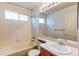 Traditional bathroom with tub, white tile, and a vanity with a large mirror at 10486 Cheetah Winds, Lone Tree, CO 80124
