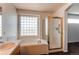 Bathroom features double sinks, white tile accents, and a combined bathtub/shower with a glass enclosure at 10486 Cheetah Winds, Lone Tree, CO 80124