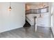 Open-concept living room with hardwood floors, a staircase, and stylish pendant lighting fixtures at 10486 Cheetah Winds, Lone Tree, CO 80124