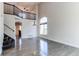 Bright and airy living room featuring hardwood floors, a high ceiling, and a staircase at 10486 Cheetah Winds, Lone Tree, CO 80124