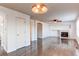 Open living room features a fireplace, ceiling fan, wood floors and arched doorways at 10486 Cheetah Winds, Lone Tree, CO 80124