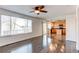 Open-concept living area with large window and view of kitchen with wooden cabinetry at 10486 Cheetah Winds, Lone Tree, CO 80124