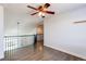Upstairs loft space overlooking the front entry featuring wood floors, black iron railing, and natural light at 10486 Cheetah Winds, Lone Tree, CO 80124